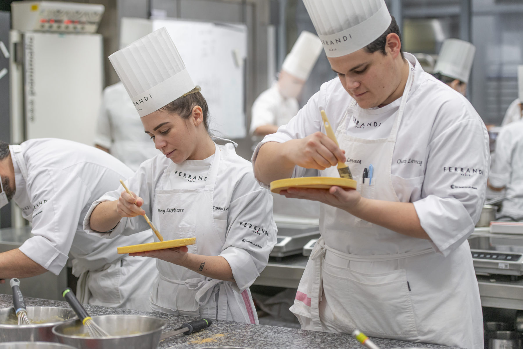 A pastry student piping meringue