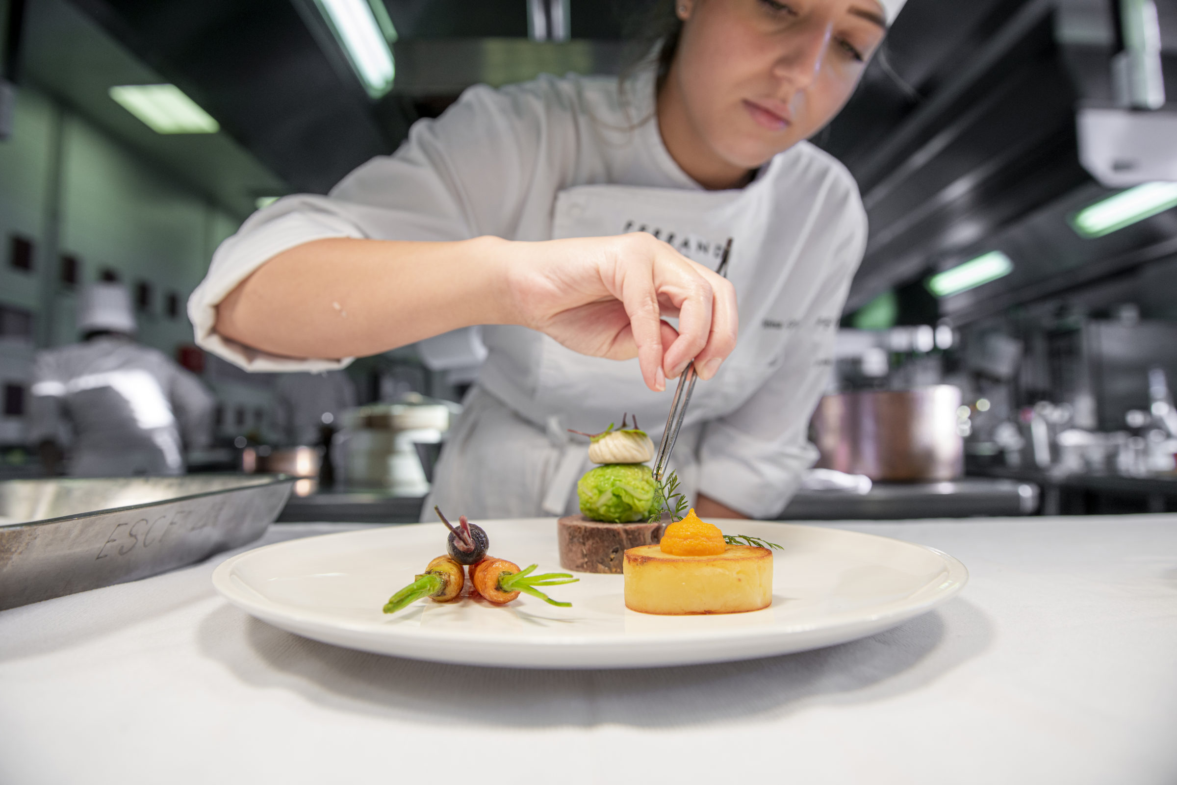 A culinary arts student plating a dish